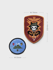 ベトナム戦時のMACV-SOG軍事刺繍ワッペンを詳細に示し、死神、虎、スカイウォーカーの図像が含まれることと、その歴史的背景と刺繍技術の卓越性を強調。