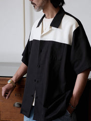 白黒のパッチワークとキューバ襟が特徴のシャツ