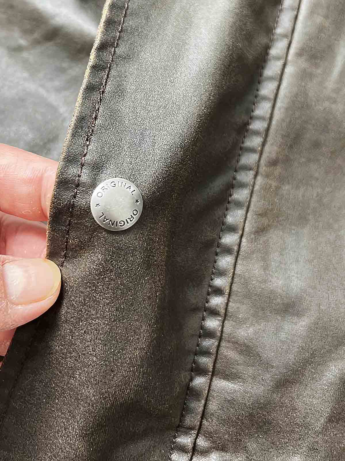 製品画像：オイルワックスヴィンテージハンティングジャケットの正面展示。クラシックでタフなアメリカンスタイルのジャケット。
詳細画像：チェック柄の裏地と多機能ポケットのディテール。ヴィンテージ感と実用性を兼ね備えたデザイン。