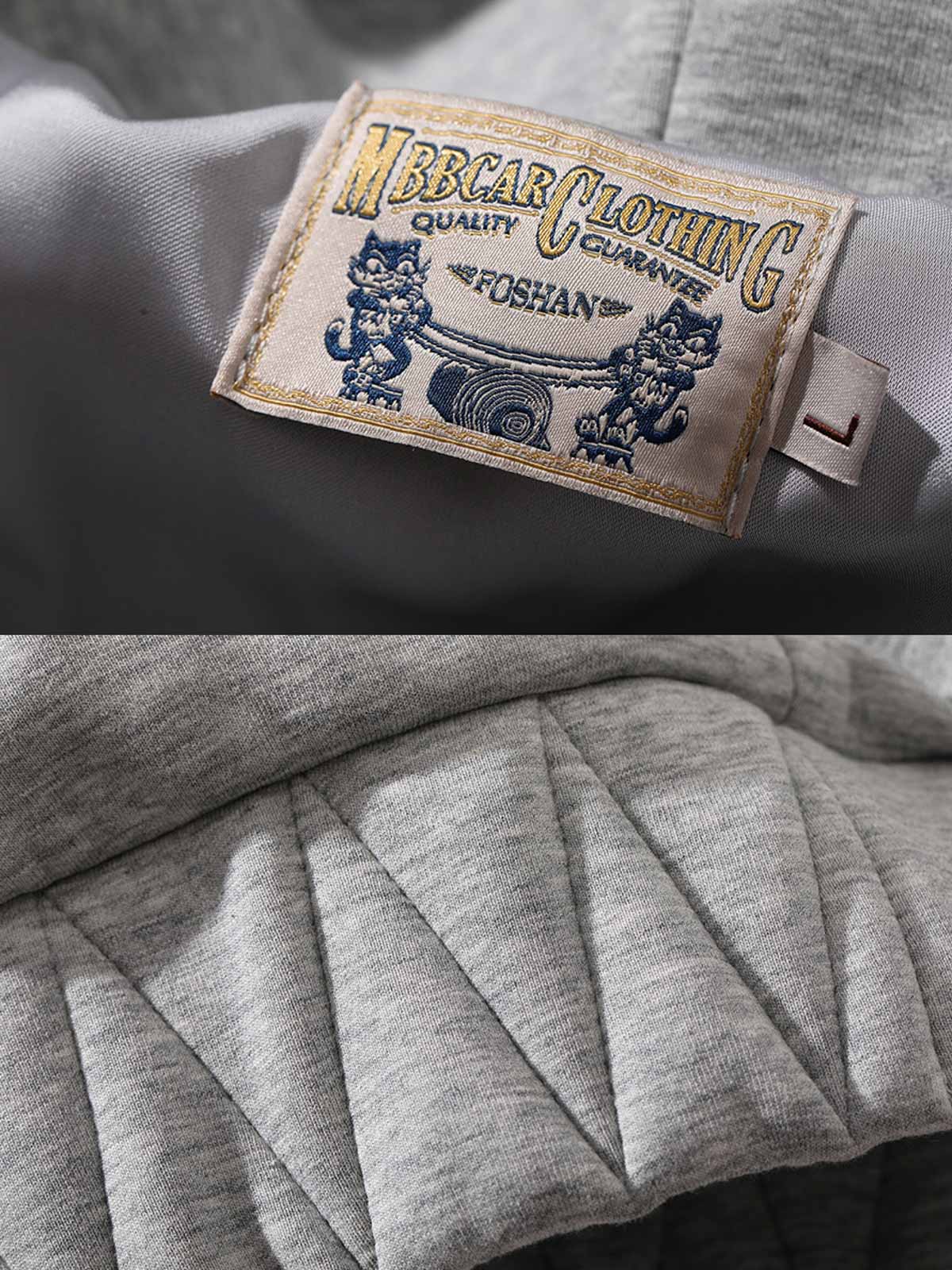 製品画像: グレーのエアレイヤースタイルカットフード付きパーカの正面展示
詳細画像: ダブルジップメタルファスナーと三角カットデザインのディテール展示