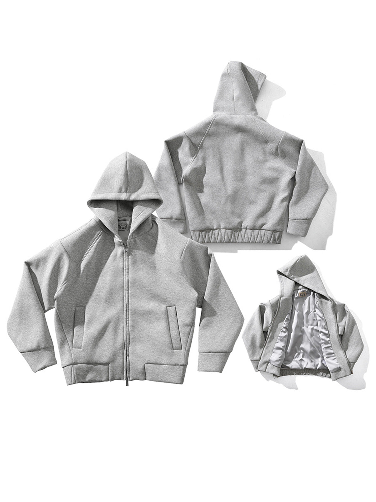 製品画像: グレーのエアレイヤースタイルカットフード付きパーカの正面展示
詳細画像: ダブルジップメタルファスナーと三角カットデザインのディテール展示