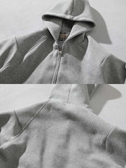 製品画像: グレーのエアレイヤースタイルカットフード付きパーカの正面展示
詳細画像: ダブルジップメタルファスナーと三角カットデザインのディテール展示