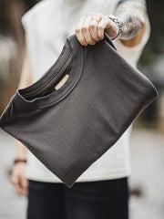 ヘビーウェイトのコットンハスク素材の詳細とダブルレイヤーのアームホールのクローズアップ。素材の厚みと耐摩耗性を強調し、デザインの階層感を示しています。