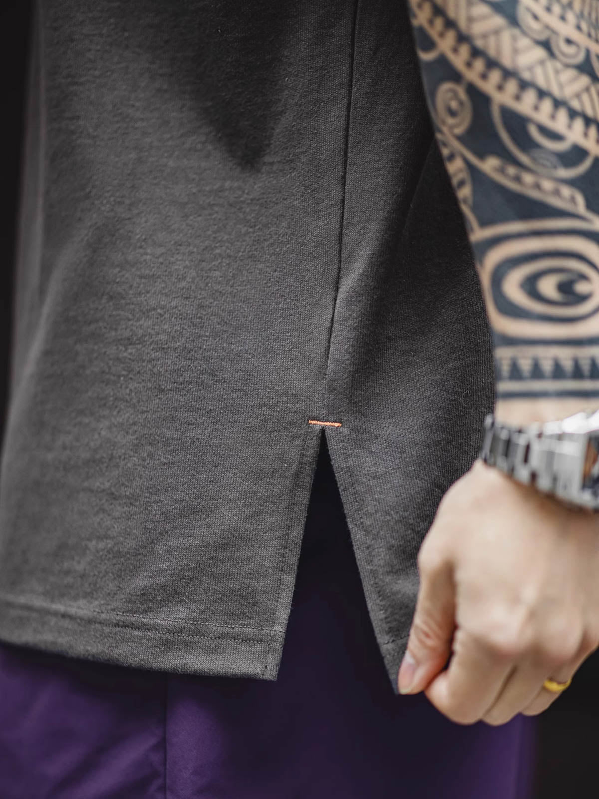 モデルがヘビーウェイトコットンハスクのスリーブレスTシャツを着用し、ルーズフィットのショートパンツとスポーツシューズでスタイリング。リラックスしたカリフォルニアの夏のスタイルを演出しています。