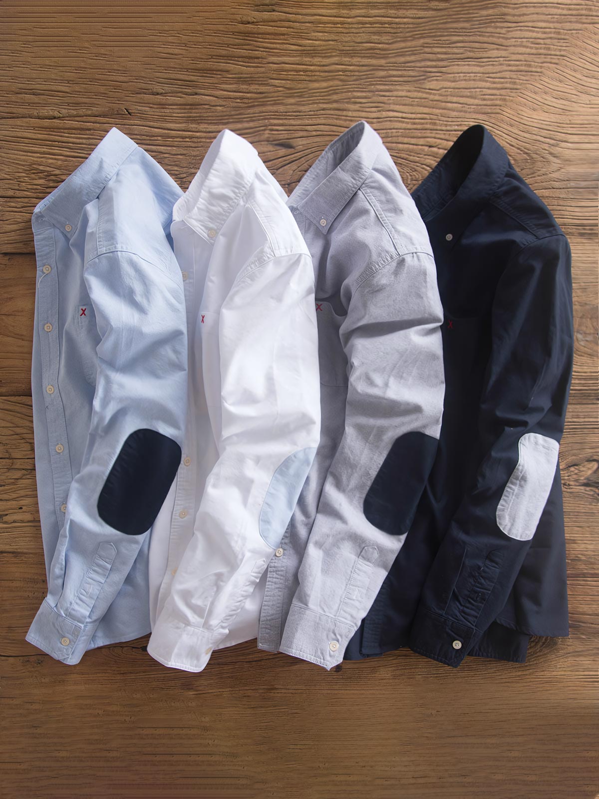 製品画像: パッチワークデザインが施されたオックスフォードシャツの正面全体展示。