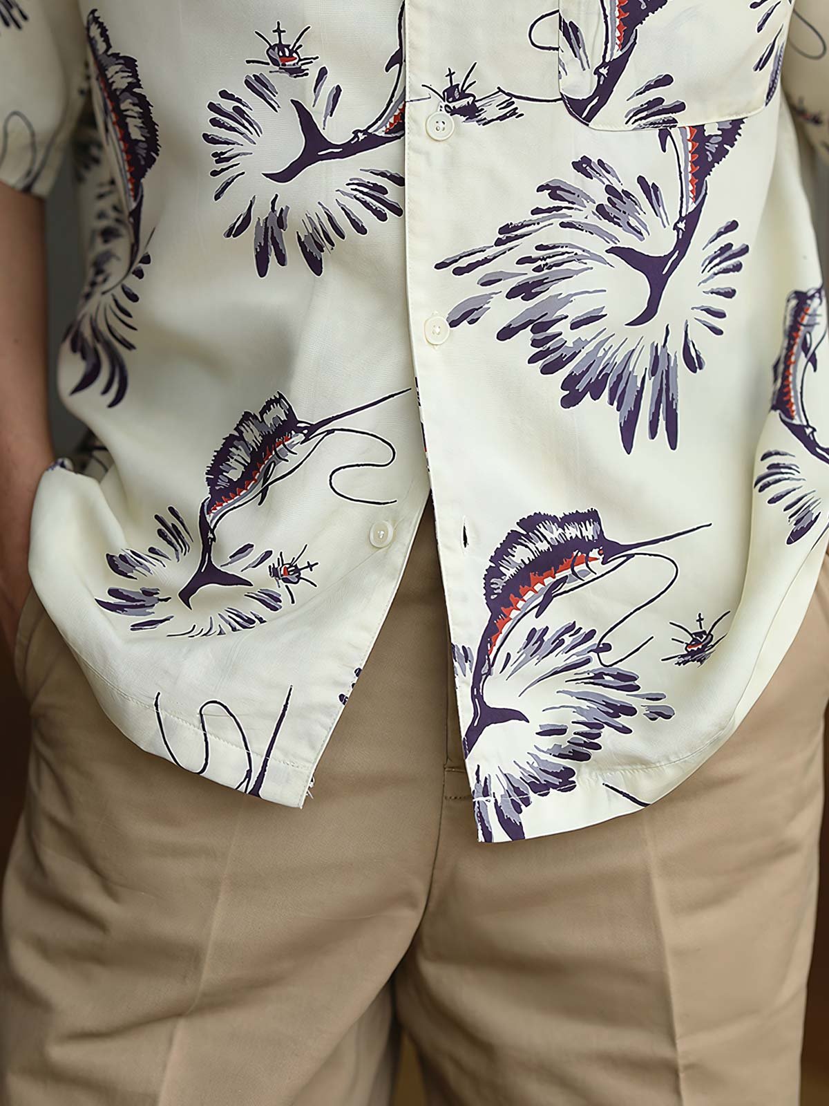 ハワイアンシャツのカジキプリントと高品質な樹脂製ボタンのクローズアップ。