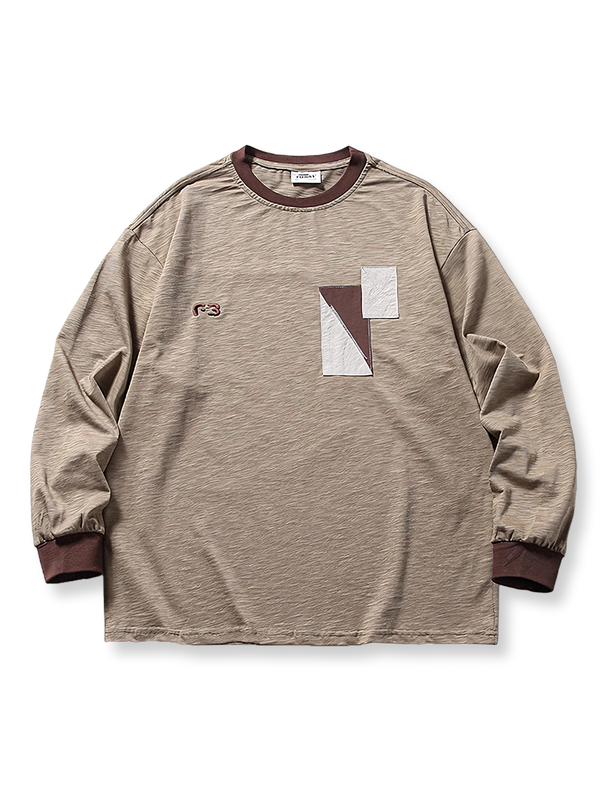 切り替えパッチワークと刺繍が特徴の2色展開長袖Tシャツ。