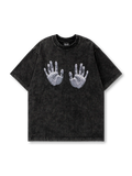 ヴィンテージウォッシュ加工のブラックコットンTシャツに実寸大の両手シルクスクリーンプリントを施したオーバーサイズTシャツ。