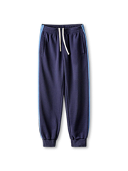 ネイビー系のワッフル地スウェットパンツ、サイドライン入り、ドローコード付きウエストと裾リブ仕様