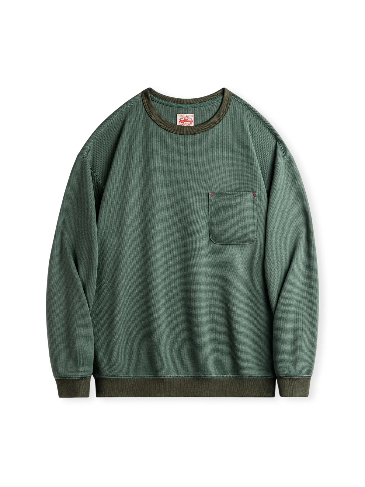 苔藻グリーンアクセントの3Dワッフルチェック生地ロングTシャツ。高めの胸ポケットとエラスティックリブ袖口・裾が特徴