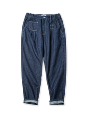 ツープリーツとウエストゴムを備えた12.8ozコットン×ポリエステル混紡デニムのテーパードパンツ。アシンメトリーポケットとムーンバックルがアクセントのヴィンテージ風デザイン。