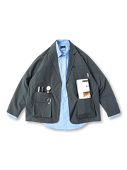 ルーズシルエットと多ポケットが特徴のポリエステル製テーラードジャケット。クラシックな3ボタンスタイルにワーク調ステッチを施し、通勤や休日のカジュアルスタイルに最適。快適な着心地と収納力を両立。